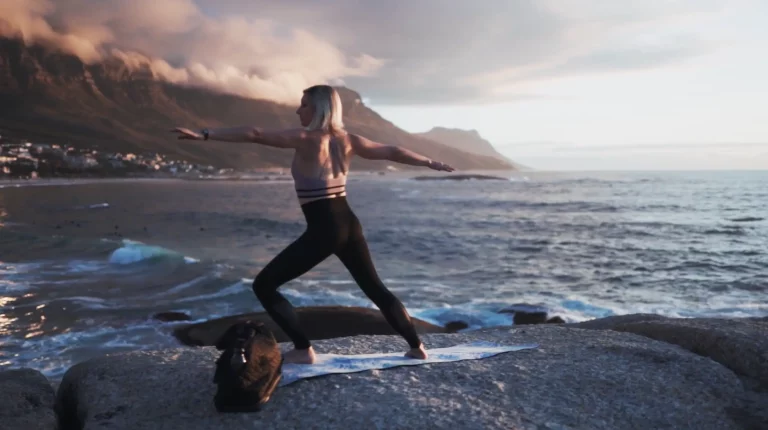 Image of a girl doing yoga on a cliff by the ocean
