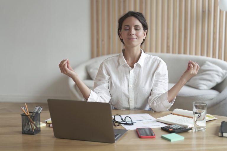 Image of female doing yoga at her work desk